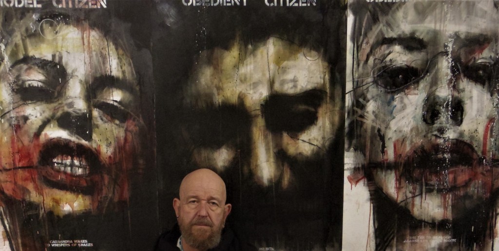 Guy Denning and three multimedia paintings.